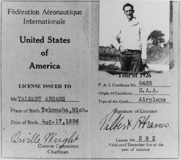 Black and white photo of pilot's license with a picture of Ted Abrams, his signure and the signature of Orville Wright.