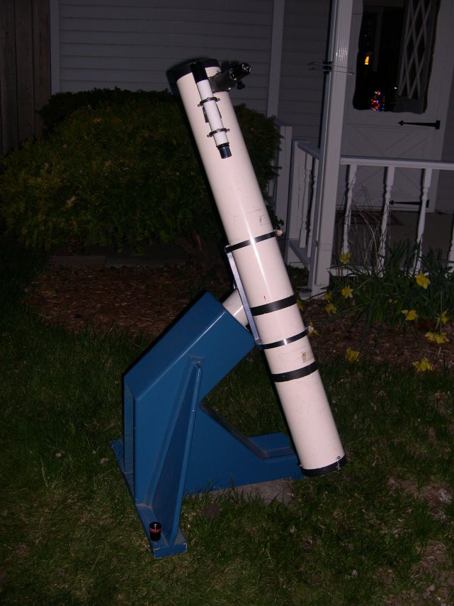 Reflecting telescope in white tube in a dark backyward